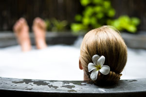 woman relaxing in an outdoor hot tub